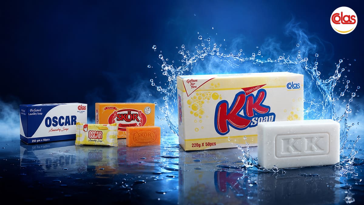 The Colas range — OSCAR, SKOR and KK soaps — lit against a deep blue background with a crown of splashing water.