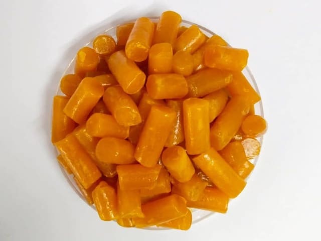 A dish of orange soap noodles, the raw material Colas supplies to other manufacturers.