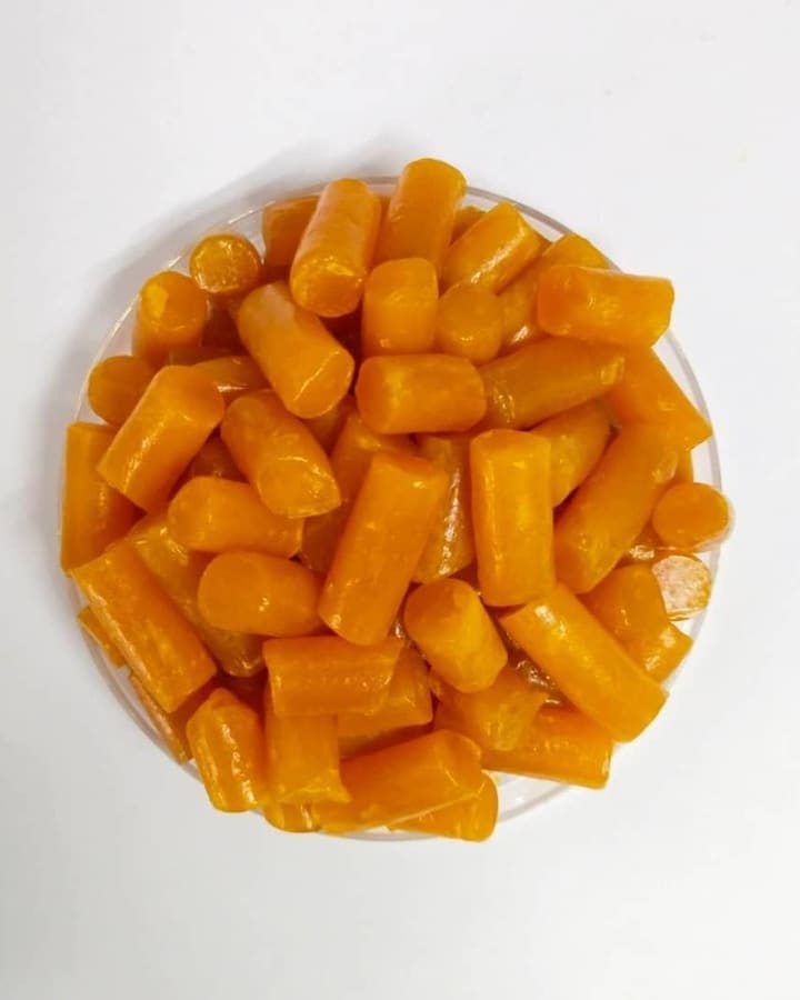 Orange soap noodles in a glass dish, seen from above.